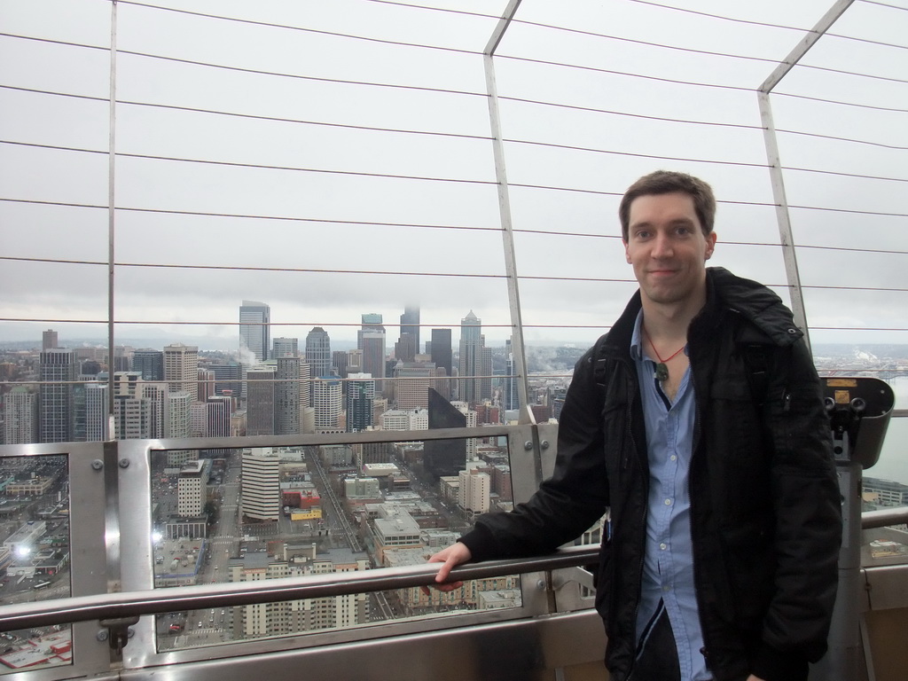 Tim with the skyline of Seattle, at the observation deck of the Space Needle