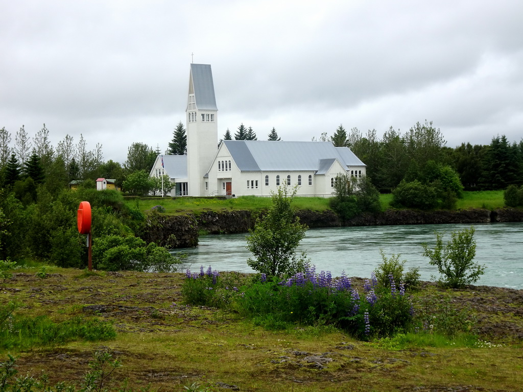 The Selfoss Kirkja church and the Ölfusá river, viewed from the parking place of Hotel Selfoss