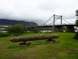 Wooden pole at the parking place of Hotel Selfoss, with a view on the Ölfusárbrú bridge over the Ölfusá river