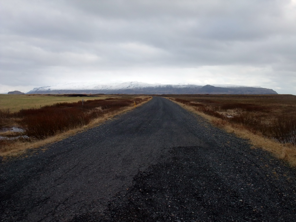 Road, grassland and mountains at a town near the Seljalandsfoss waterfall