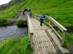 Max on the bridge over the stream at the Seljalandsfoss waterfall