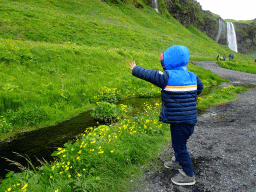 Max at the stream at the north side of the Seljalandsfoss waterfall