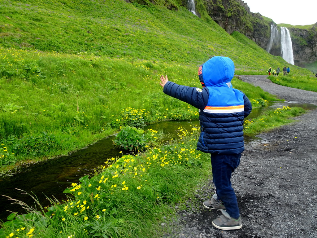 Max at the stream at the north side of the Seljalandsfoss waterfall