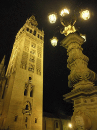 The Giralda tower and a street lantern, by night