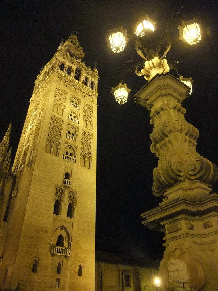The Giralda tower and a street lantern, by night