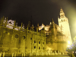 The east side of the Seville Cathedral with the Giralda tower at the Plaza del Triunfo square, by night