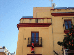 Santa Claus hanging from a balcony at the restaurant `El Cordobes` in the Calle Santa Maria la Blanca street