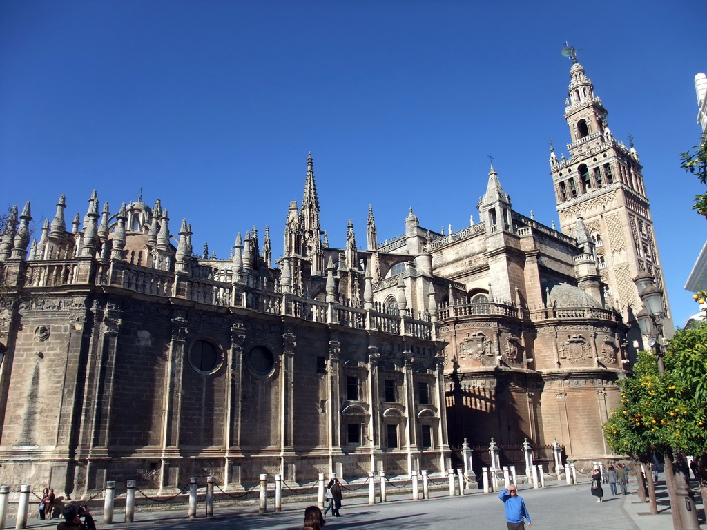 The east side of the Seville Cathedral with the Giralda tower at the Plaza del Triunfo square