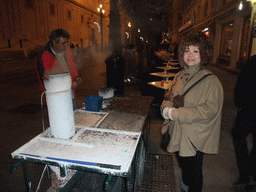 Miaomiao with chestnut salesman in the Avenida de la Constitución avenue at the west side of the Seville Cathedral, by night