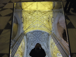 Tim with a mirror and the reflection of the ceiling of the Seville Cathedral