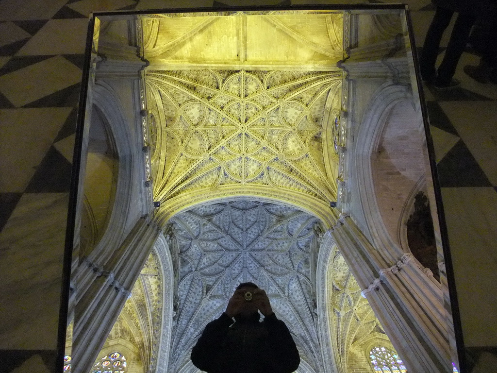 Tim with a mirror and the reflection of the ceiling of the Seville Cathedral