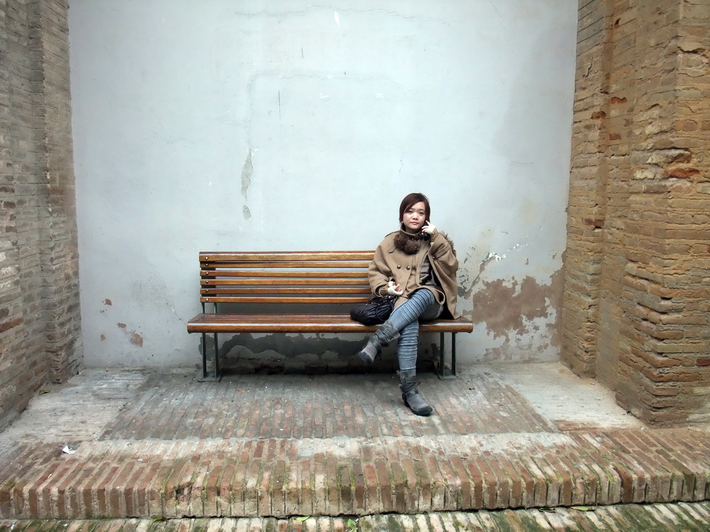 Miaomiao on a bench at the Patio de los Naranjos courtyard