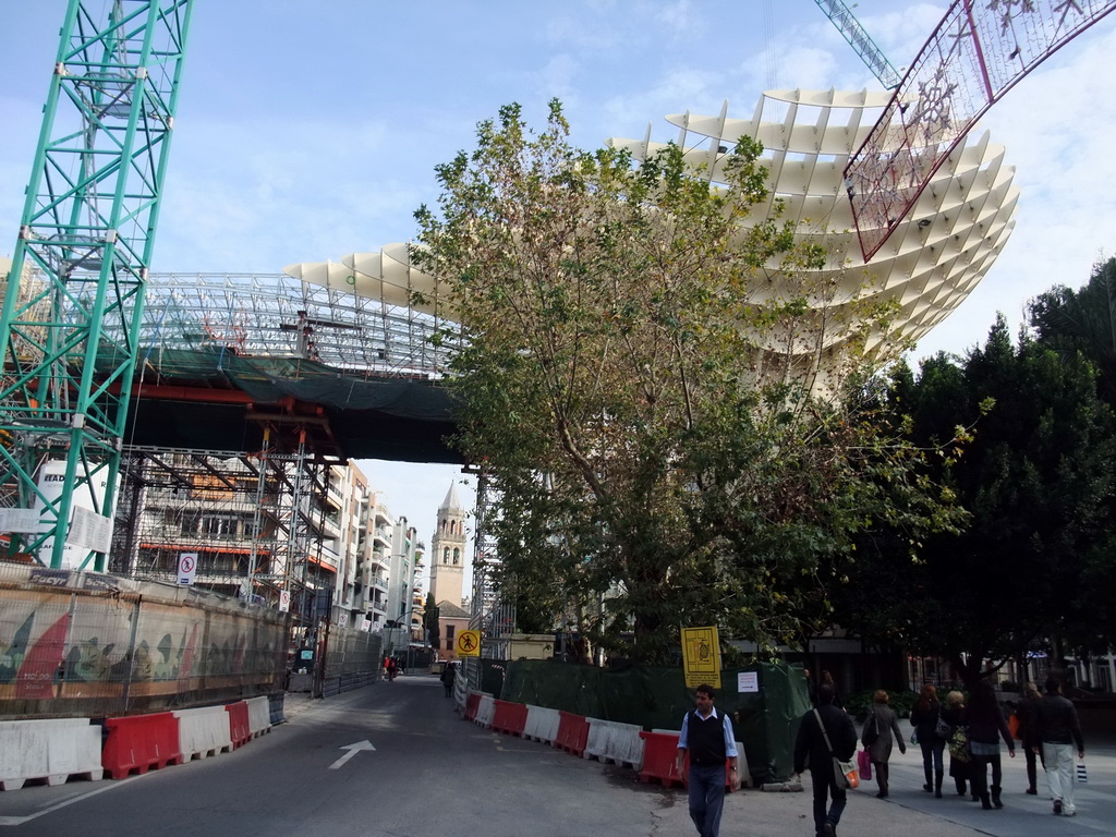 The Metropol Parasol de la Encarnación, under construction, at the Plaza de la Encarnación square, and the tower of the Iglesia de San Pedro church