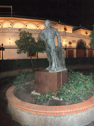 Statue of Curro Romero in front of the Plaza de Toros de la Real Maestranza de Caballería de Sevilla bullring, by night