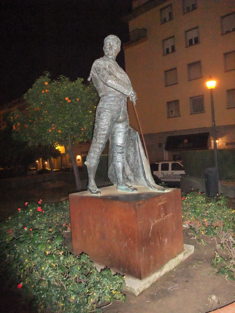 Statue of Curro Romero in front of the Plaza de Toros de la Real Maestranza de Caballería de Sevilla bullring, by night