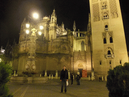 Tim at the east side of the Seville Cathedral with the Giralda tower at the Plaza del Triunfo square, by night