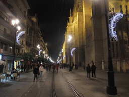 The Avenida de la Constitución avenue, with the west side of the Seville Cathedral, by night