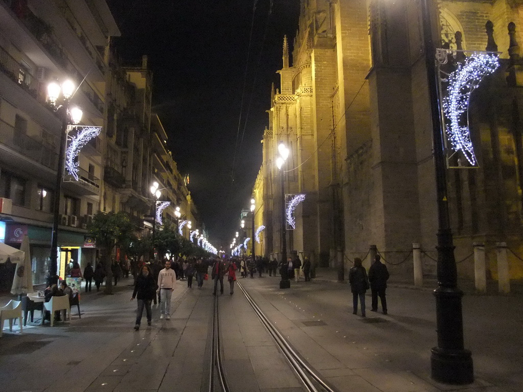 The Avenida de la Constitución avenue, with the west side of the Seville Cathedral, by night