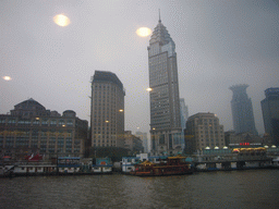The Bund area with the Bund Center, the Guang Ming Building and restaurant boats, viewed from the Huangpu river ferry