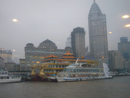 The Bund area with the Guang Ming Building and restaurant boats, viewed from the Huangpu river ferry