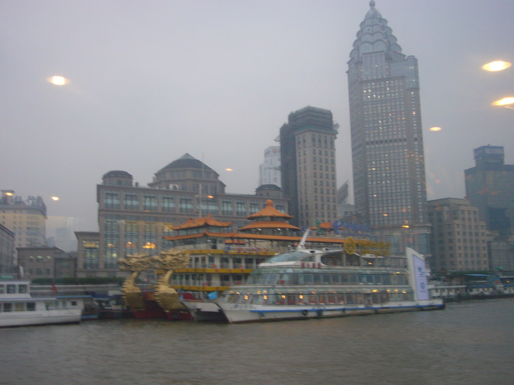 The Bund area with the Guang Ming Building and restaurant boats, viewed from the Huangpu river ferry