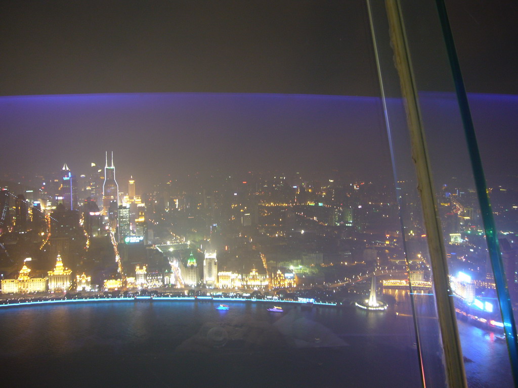 View on the Puxi skyline and the Bund area, with the Monument to the People`s Heroes at Huangpu Park, Tomorrow Square, Le Royal Méridien Shanghai and other skyscrapers, from the top of the Oriental Pearl Tower, by night