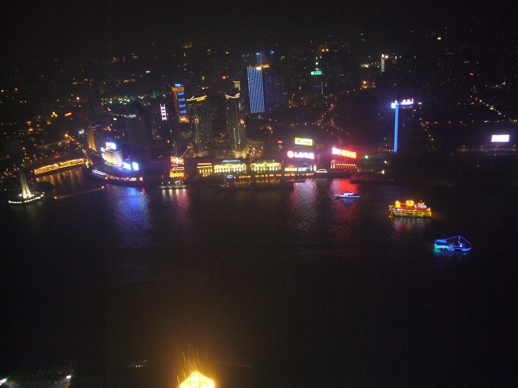 View on the northern part of the Huangpu river and surroundings, with the Monument to the People`s Heroes at Huangpu Park, the Hyatt on the Bund and other skyscrapers, from the top of the Oriental Pearl Tower, by night