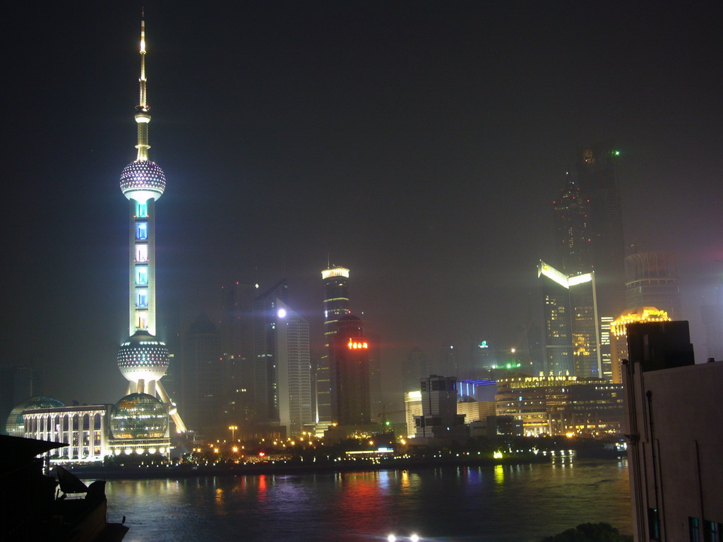 Skyline of the Pudong district, with the Oriental Pearl Tower, the Jin Mao Tower and the Shanghai World Financial Center (under construction), viewed from the roof of the Ambassador Hotel, by night