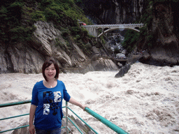 Miaomiao at the rapids and bridge at Tiger Leaping Gorge