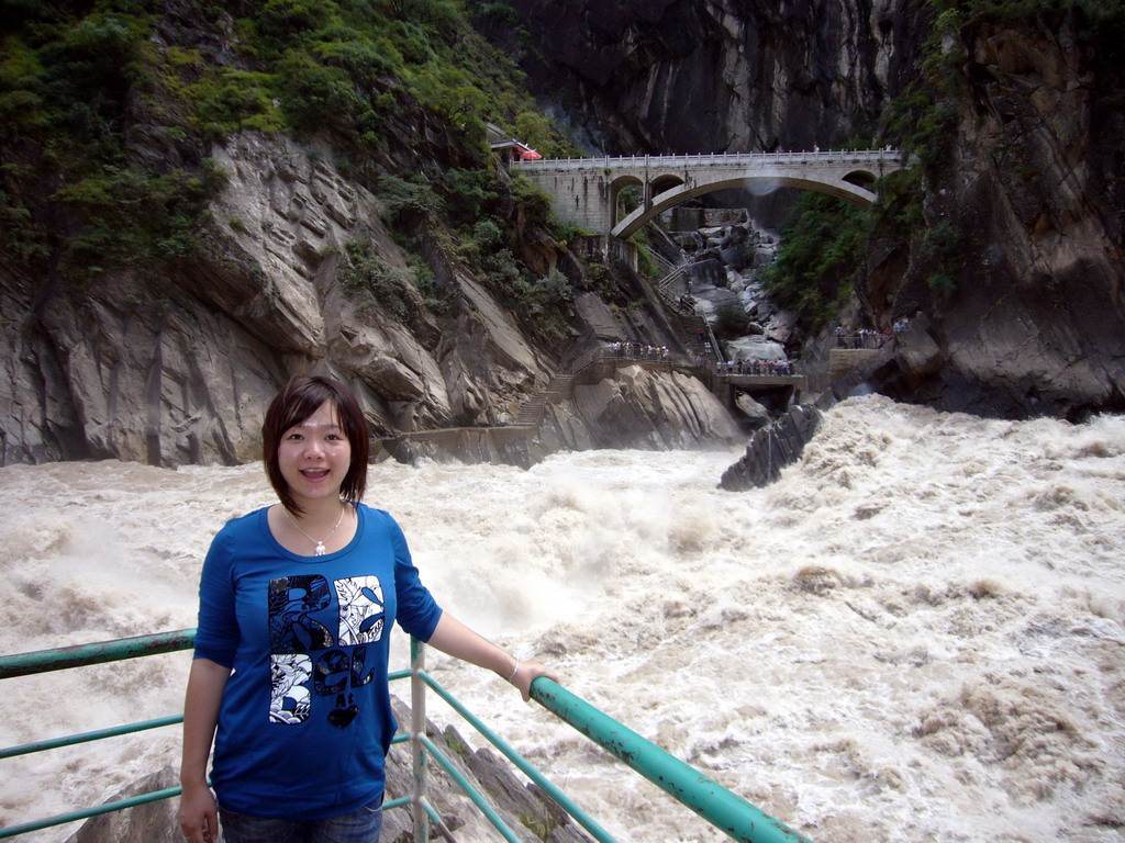 Miaomiao at the rapids and bridge at Tiger Leaping Gorge