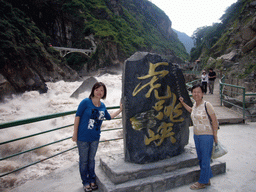 Miaomiao and Miaomiao`s mother with monument stone at Tiger Leaping Gorge