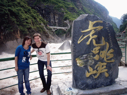 Tim and Miaomiao with monument stone at Tiger Leaping Gorge