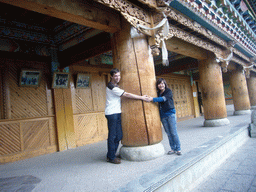 Tim and Miaomiao with a wooden pillar of a Tibetan buddhism temple