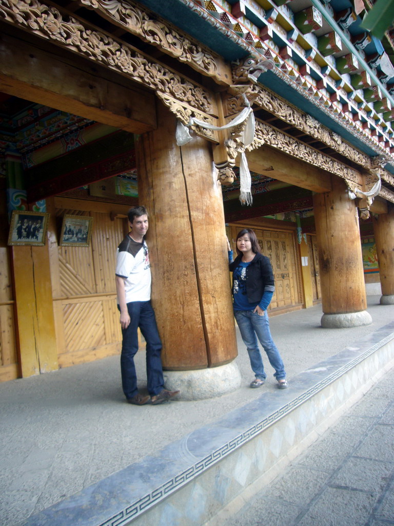 Tim and Miaomiao with a wooden pillar of a Tibetan buddhism temple