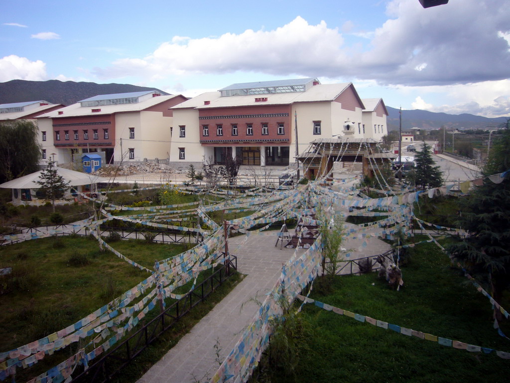 Garden, stupa and prayer flags, viewed from the upper floor of a Tibetan buddhism temple