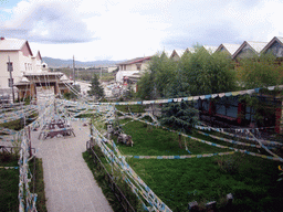 Garden, stupa and prayer flags, viewed from the upper floor of a Tibetan buddhism temple