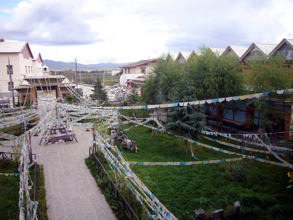 Garden, stupa and prayer flags, viewed from the upper floor of a Tibetan buddhism temple