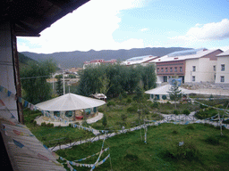 Garden and prayer flags, viewed from the upper floor of a Tibetan buddhism temple