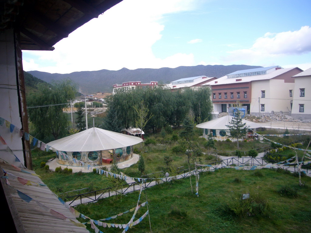 Garden and prayer flags, viewed from the upper floor of a Tibetan buddhism temple