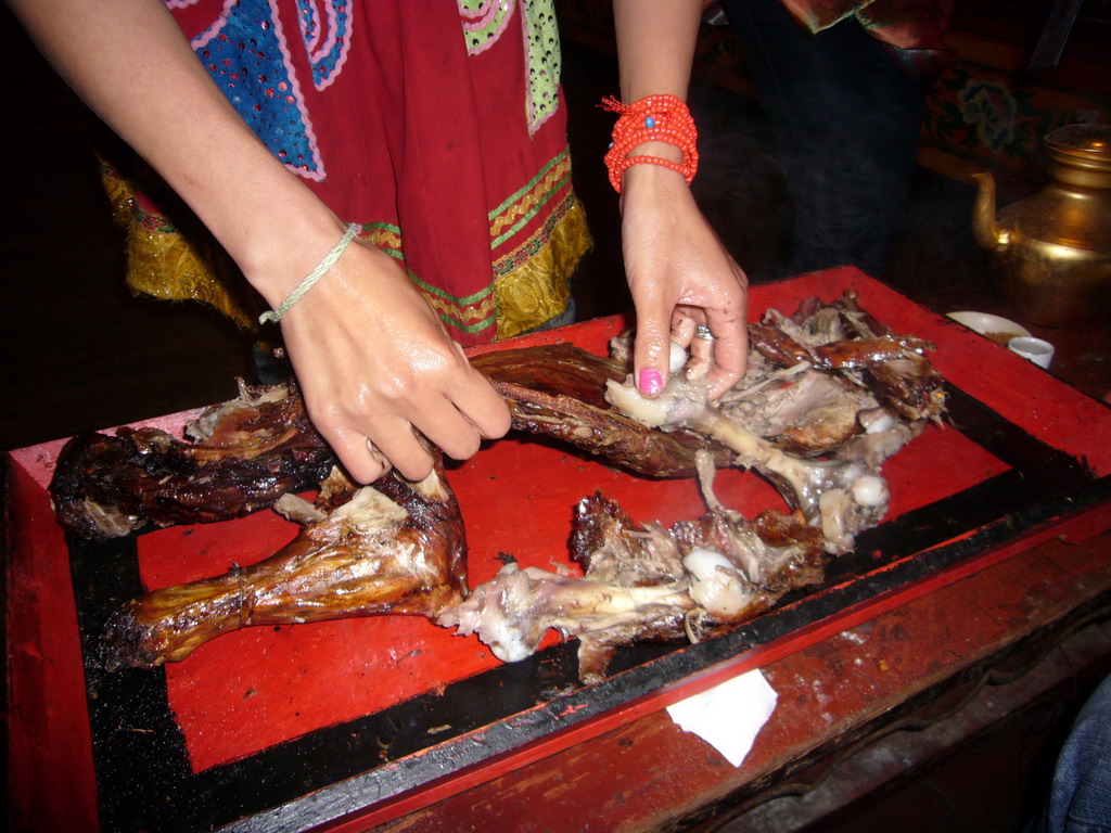 Yak meat being prepared on our table in the Tibetan dinner house