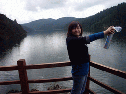 Miaomiao with oxygen bottle at Bita Lake in Potatso National Park