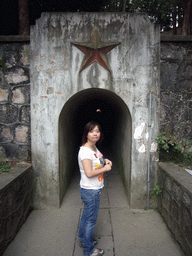 Miaomiao in front of a tunnel leading to another part of the town