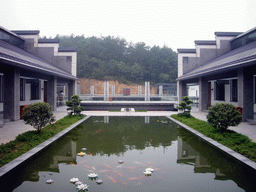 Top floor of the Shaoshan Mao Zedong Relic Museum, with a pond and a large version of Mao Zedong`s stamp