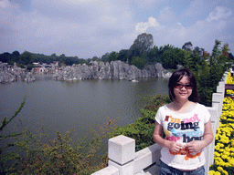 Miaomiao at lake with karst formations in Shilin National Park