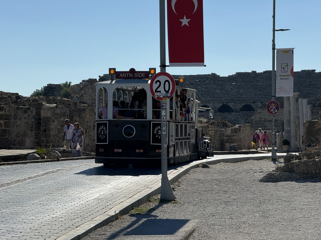 Tram at the Liman Caddesi street, with a view on the Roman Theatre of Side