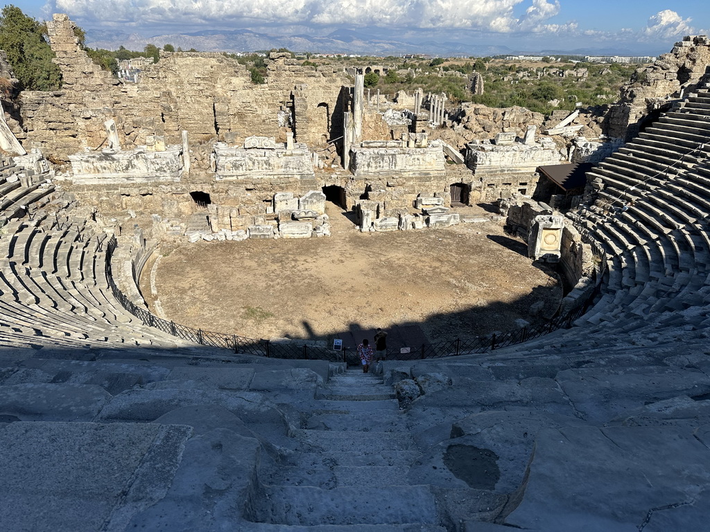 Tim and Max at the bottom of the southwest auditorium of the Roman Theatre of Side, with a view on the orchestra, stage and stage building, viewed from the diazoma