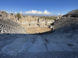 Tim at the bottom of the southwest auditorium of the Roman Theatre of Side, with a view on the auditorium, orchestra, stage and stage building, viewed from the diazoma