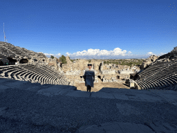 Miaomiao at the diazoma of the southwest auditorium of the Roman Theatre of Side, with a view on the auditorium, orchestra, stage and stage building