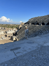 Miaomiao at the diazoma of the southwest auditorium of the Roman Theatre of Side, with a view on the auditorium, orchestra, stage and stage building