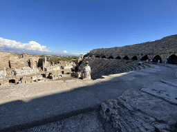 Miaomiao at the diazoma of the southwest auditorium of the Roman Theatre of Side, with a view on the auditorium, orchestra, stage and stage building